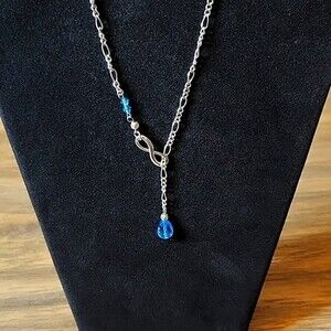 NWT Silvertone Infinity Necklace with Dangling Blue Rhinestone Bead